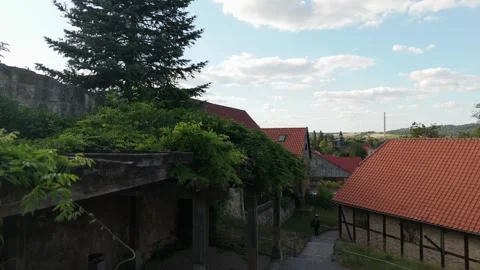 Aerial drop for a half timbered house and old stone wall above Blankenburg 스톡 동영상 337978837