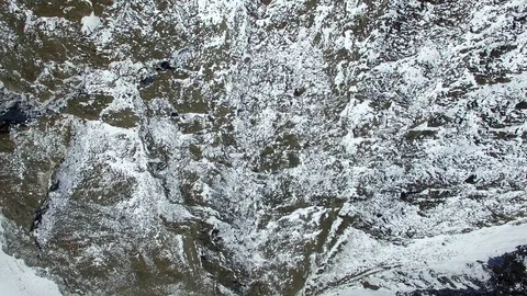 Aerial drown flight with straight down view on rocky snowy mountain with 스톡 동영상 91014930