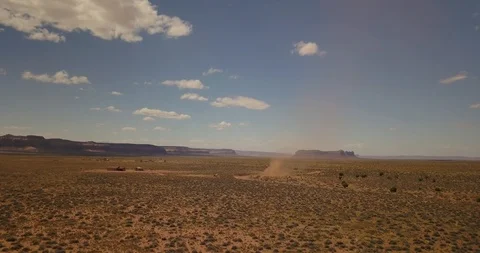 Aerial - a dust devil blows across the desert of Monument Valley Stock Footage 107113313