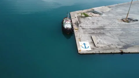 Aerial dynamic view of industrial ship at port with breakwater Stock Footage 337462744