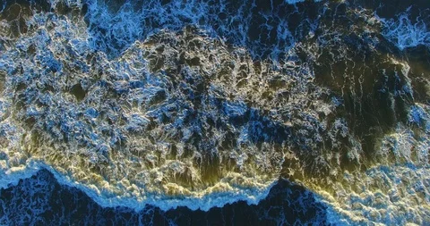 Aerial dynamic view from a top to green sea illuminated by sun - 015 Stock Footage 128575944