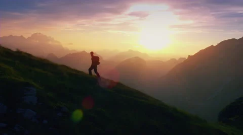Aerial, edited - Epic shot of a man hiking on the edge of the mountain Stock Footage