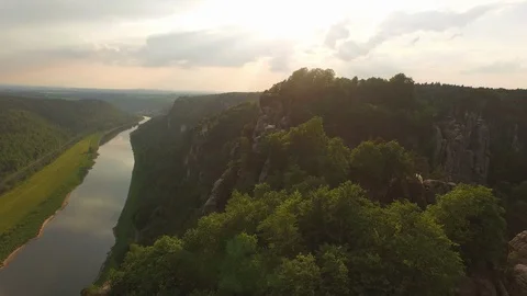 Aerial of Elbe river and Elbe Sandstone Mountain surrounded by green trees Stock Footage 116190352