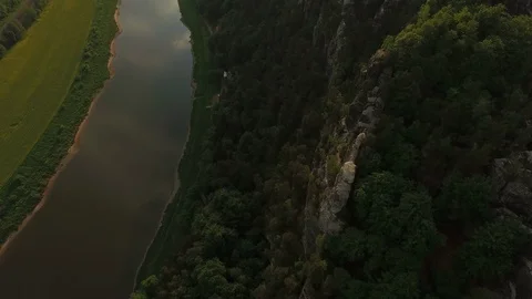 Aerial of Elbe river and Elbe Sandstone Mountain surrounded by green trees Stock Footage 116190871