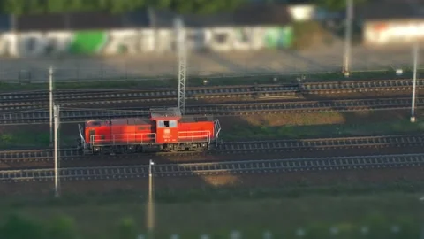 Aerial of Electric Locomotive Engine on Multiple Tracks Railway Tilt-Shift Stock Footage 229780935