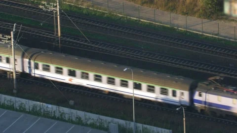 Aerial of Electric Passenger Train on Multiple Tracks Railway Stock Footage 229780801