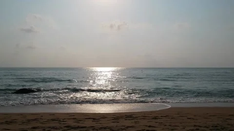 Aerial Elevating Drone Shot. Sunset and the ocean coast. View of the sea waves Stock Footage 134324582