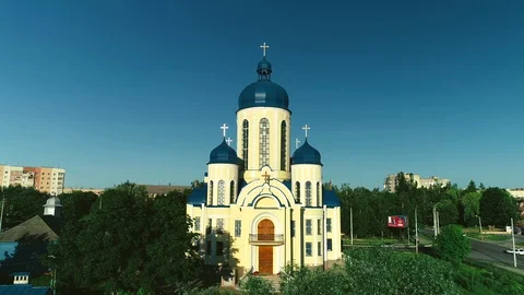 Aerial elevating up over a church with blue domes. 4K. Stock Footage 113066409