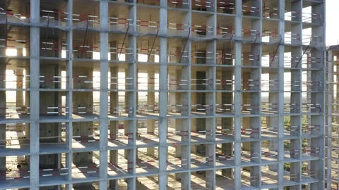 Aerial elevator shot of a concrete skeleton of a building under construction Stock Footage 143025551