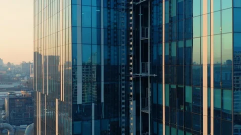 Aerial elevator shot of glassed skyscraper exterior with a city reflection Stock Footage 126885031