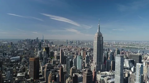 Aerial of Empire State building surrounded with buildings in New York City Vídeo Stock 76134023