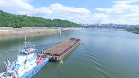 AERIAL: An empty barge floats along the river Stock Footage 87064647