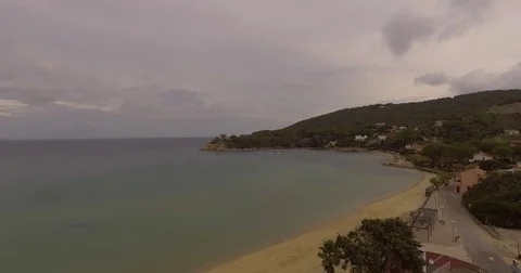Aerial, empty beach and beautiful calm sea on cloudy day Stock Footage 83321384