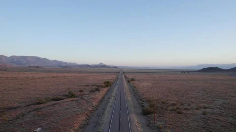 Aerial of an empty road running through a barren desert Stock Footage 246016369