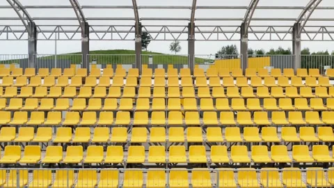 Aerial empty stadium seats during coronavirus COVID-19. Rows and yellow seats Stock Footage 138602263