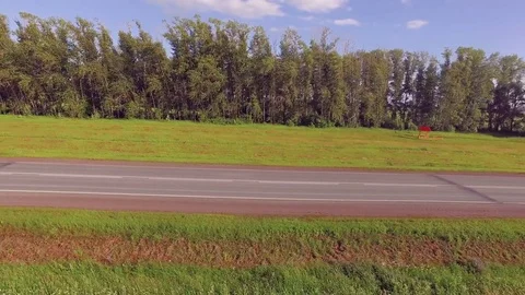 AERIAL: Empty two-lane highway along the forest belt. Outdoors, travel. Video stock 82468942