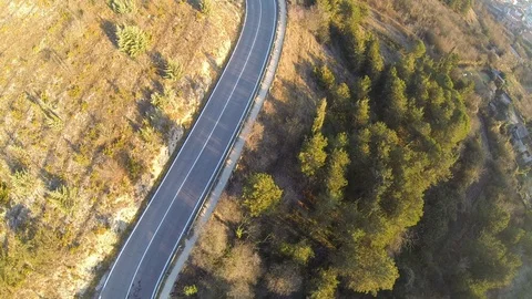 Aerial of empty winding road on mountain on a sunny day Stock Footage 89966179