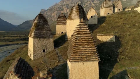 Aerial epic ancient Caucasus crypts tomb burial ground Dargavs alpine dead city Stock Footage 150991715