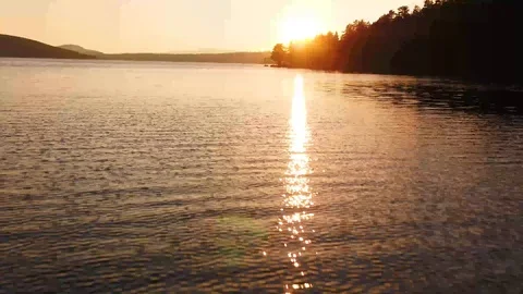 Aerial - Epic with lake and forest as a silhouette in beautiful sunset Stock Footage