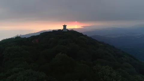 Aerial epic observation tower Mount Akhun Sochi orange sunset cityscape sea 4k Stock Footage 122022381