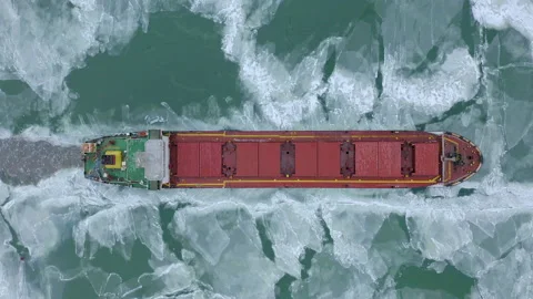 Aerial epic red ship in winter sails through frozen sea makes its way. Ice floe Stock Footage 143727036