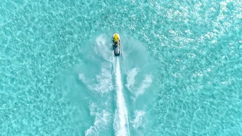 Aerial - Epic shot of a jet ski racing on a crystal clear water Stock Footage