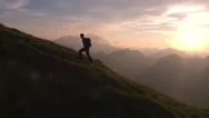 Aerial - Epic Shot Of A Man Hiking On The Edge Of The Mountain Stock Footage