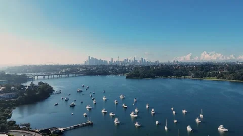 Aerial establishing pullback above luxury boats anchored in water, Drummoyne Stock Footage 312728199