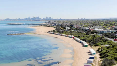 Aerial Establishing shot of bathing boxes at Brighton beach, Melbourne city Stock-Footage 157159213