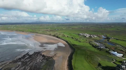 Aerial establishing shot of Trump Doonbeg hotel overlooking Doughmore Bay Stock Footage 261831519