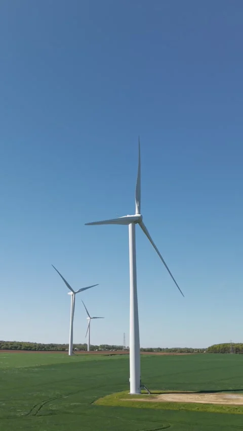 Aerial establishing view approaching Wind Turbine on farmland Stock Footage 339226439