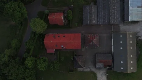 Aerial evening flight top down view over farm houses on left 4k Video stock 76910977