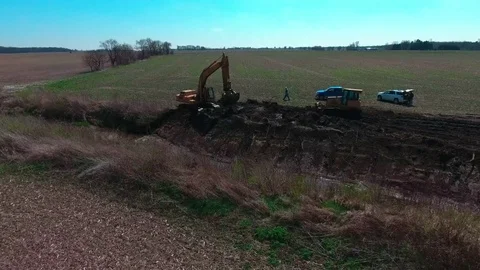 Aerial: Excavator digs at construction site Stock Footage 73901895