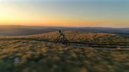 Aerial: Extreme Cross Country Cyclist Speeds Along A Mountain Trail At Sunrise. Stock Footage