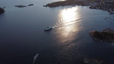 Aerial of a fast ferry navigating the Norwegian archipelago at sunset Video stock 335198563