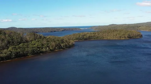 Aerial fast motion flying over Myall lake to Pacific ocean beach as 4k. Stock Footage 199328122