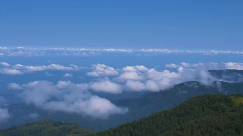 Aerial: Fast moving clouds, view from the top of the mountain Stock-Footage 115076100