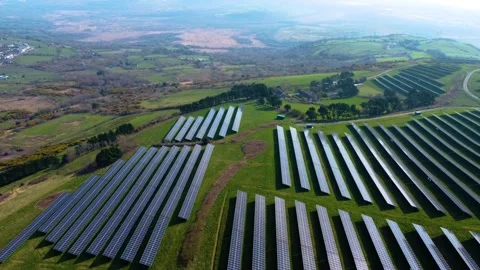Aerial of Field Landscape with Solar Panel Array on Hilltop. Stock Footage 332627012