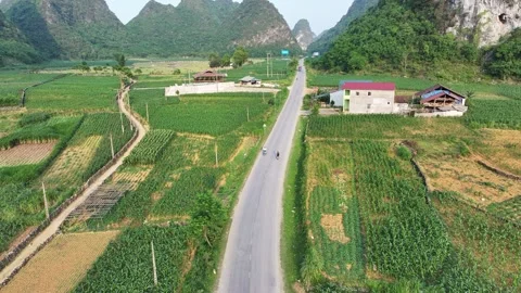 Aerial filming biker riding down the road towards Falls, Vietnam Stock Footage 284901951