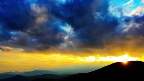 Aerial of a fire sunset with dark clouds and hills Stock Footage 315118262
