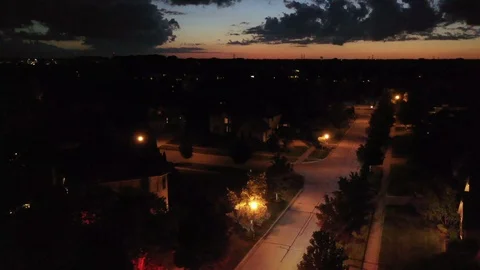 AERIAL: a fire truck and ambulance arriving at a burning house in the dead Stock Footage
