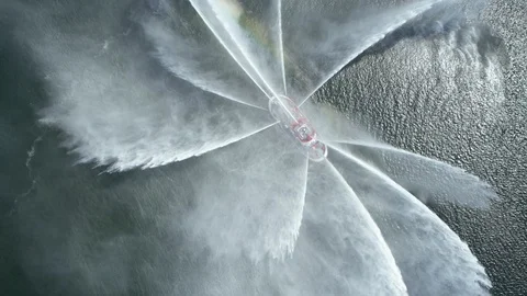 Aerial of fireboat Vigilance rotate while shooting out water 
creating rainbow Stock Footage 116481689