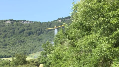 Aerial Firefighting Plane Dropping Water Over Rural Field to Extinguish Wild 動画素材 337058480
