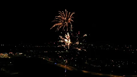 Aerial of Fireworks Exploding at Night over Highway Stock Footage 122102681