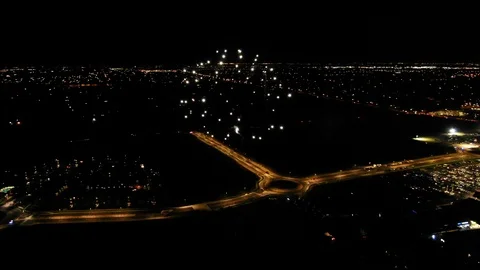 Aerial of Fireworks Exploding at Night over Interstate Stock Footage 122103623