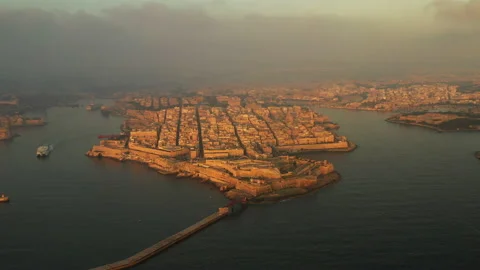 AERIAL // First light casting over Valletta Stock Footage