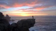 Aerial: Fisherman Standing On Top Of The Cliff And Fishing Stock Footage