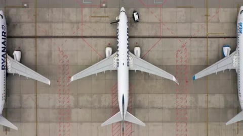 Aerial flat lay, top down view of airplanes parked on airport apron Video stock 134584724