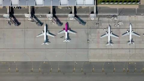 Aerial flat lay top down view of airplanes on airport apron in front of terminal Stock-Footage 134660191