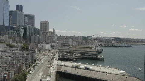 Aerial flies south over the Seattle boardwalk past the ferris wheel on sunny day Stock-Footage 158793853